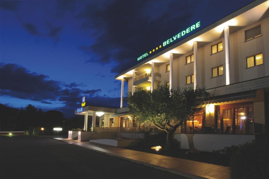 a building with a sign on it at night at Albergo Ristorante Belvedere in Codroipo