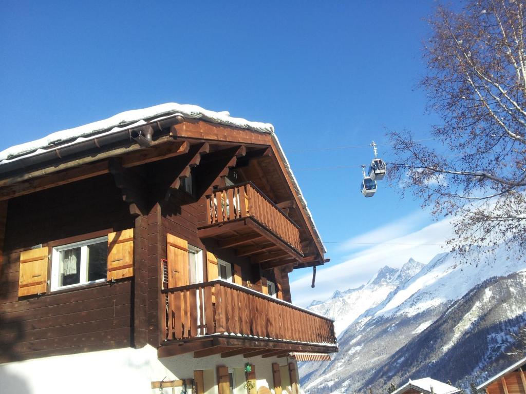 a ski lodge with a snow covered mountain in the background at Chalet Samson in Zermatt