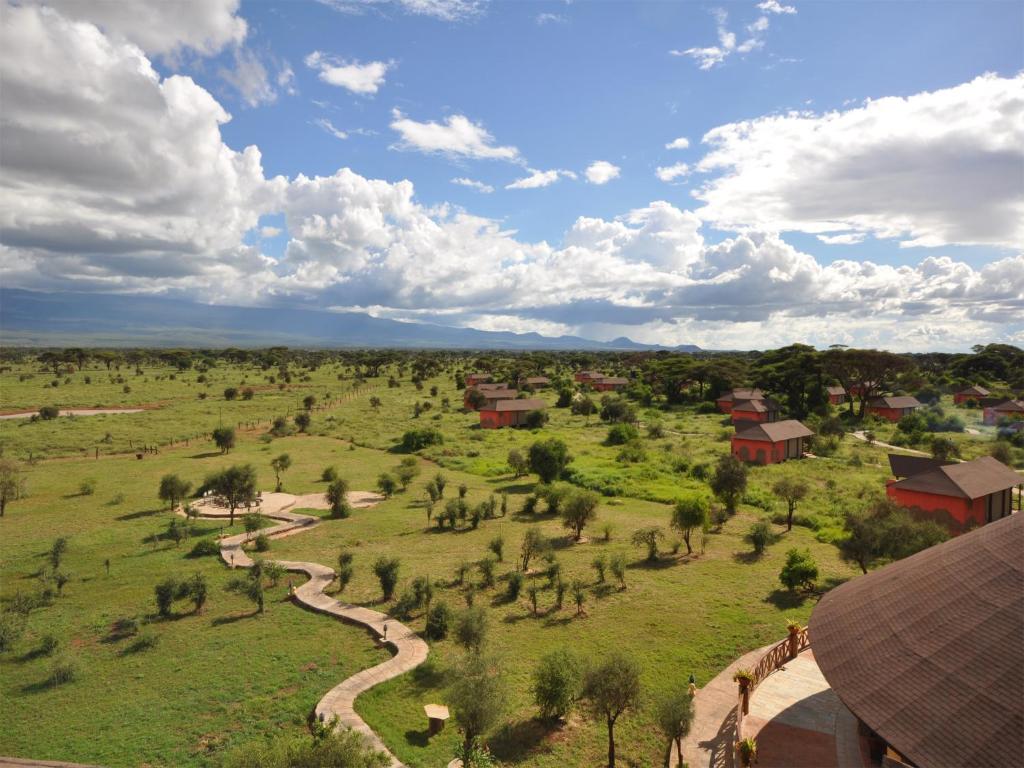 an aerial view of a field with trees and buildings at Kilima Safari Camp in Amboseli