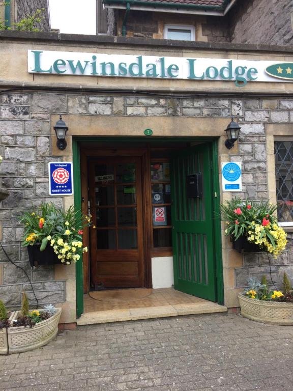 un edificio con una puerta verde y un cartel en él en Lewinsdale Lodge, en Weston-super-Mare