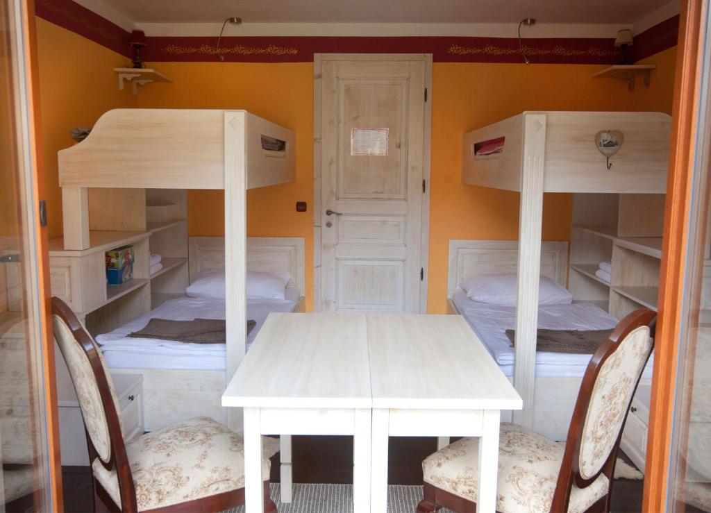 een kamer met een stapelbed en een tafel en stoelen bij Turistična kmetija Weiss in Miklavž pri Taboru