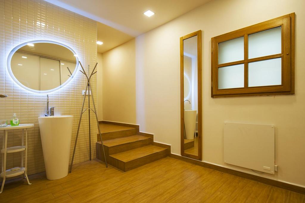 a bathroom with a staircase and a mirror at Penzion Na Náměstí in Mikulov