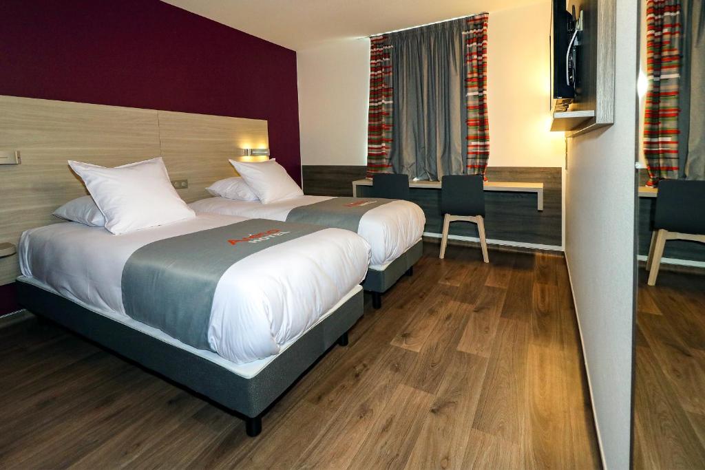 Postel nebo postele na pokoji v ubytování Hotel Arena Toulouse