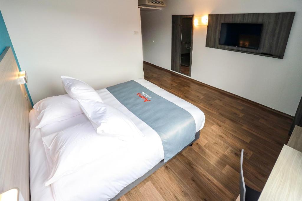 Postel nebo postele na pokoji v ubytování Hotel Arena Toulouse