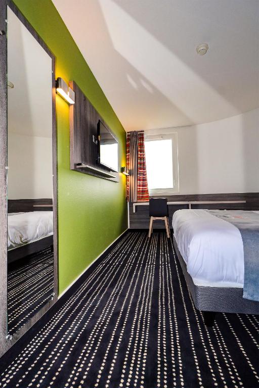 Postel nebo postele na pokoji v ubytování Hotel Arena Toulouse