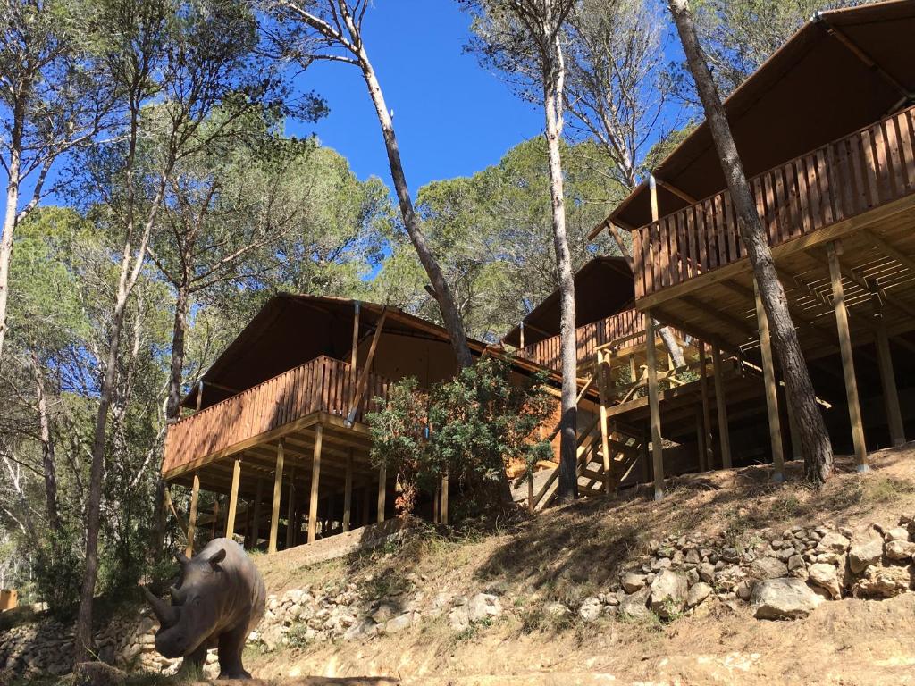 a bear standing in front of a house at Glamping Lodge Estartit in L'Estartit