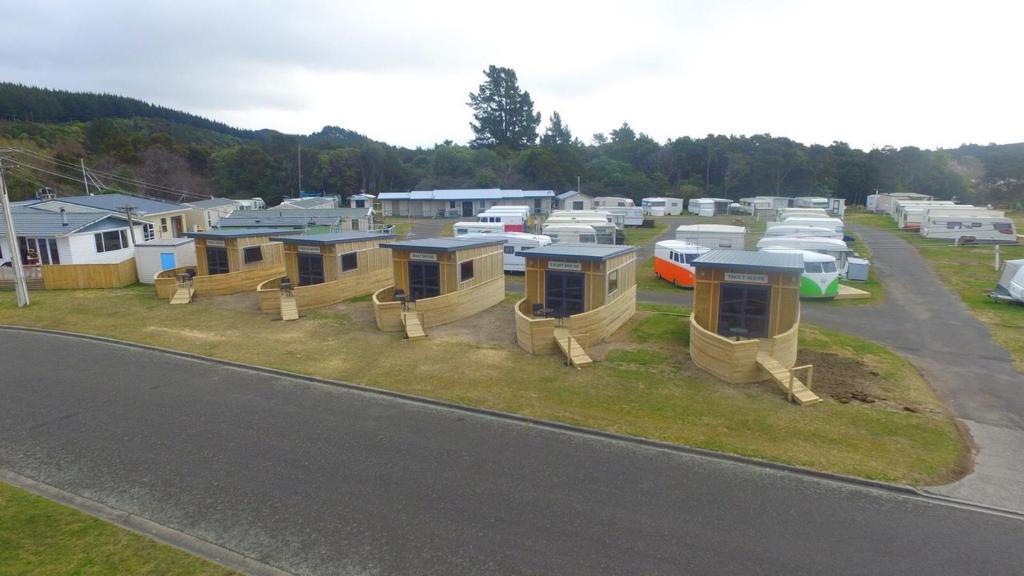 a row of tiny homes in a parking lot at Motuoapa Bay Holiday Park in Turangi