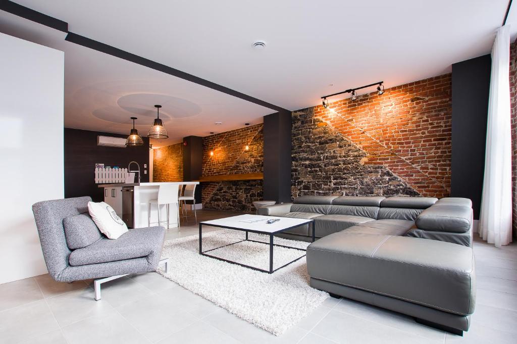 a living room with a brick wall at Les Lofts St-Joseph - Par Les Lofts Vieux-Québec in Quebec City