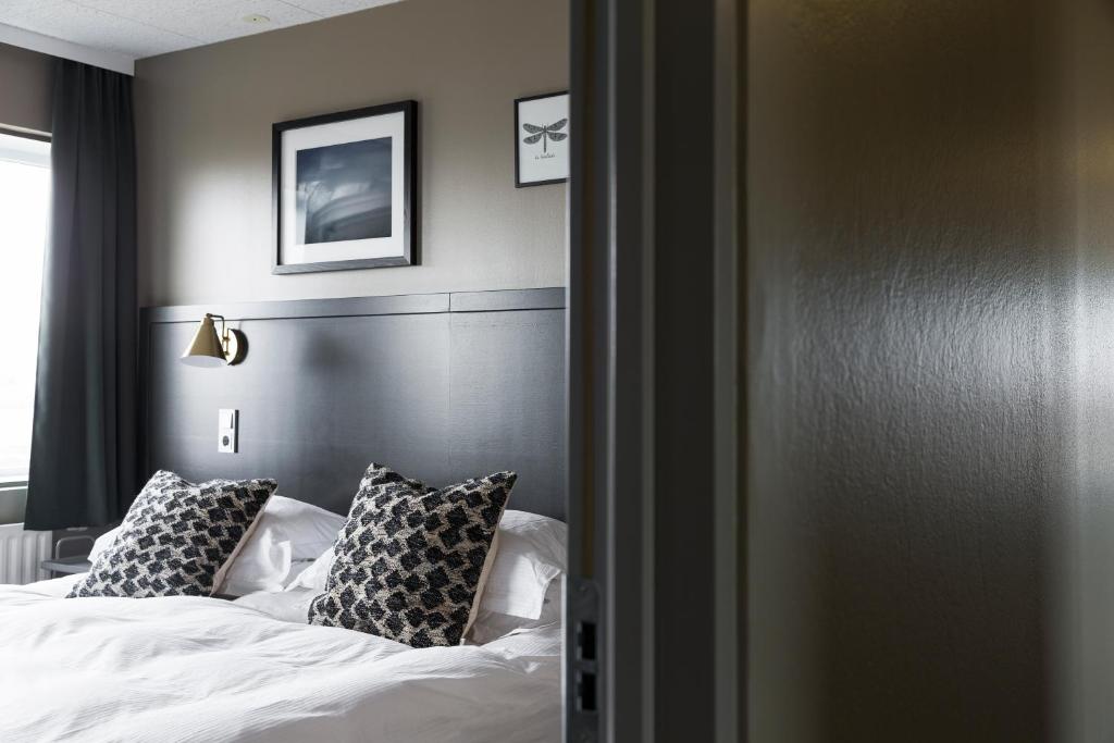 Postel nebo postele na pokoji v ubytování Hotel Höfn