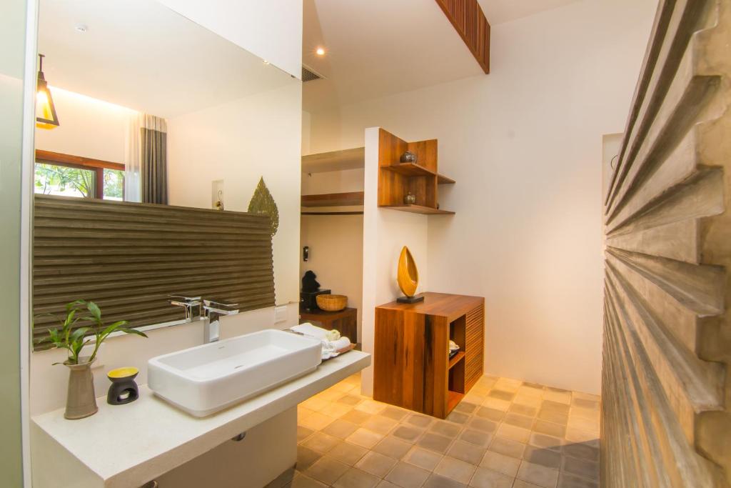 a bathroom with a white sink and a mirror at Apsara Residence Hotel in Siem Reap