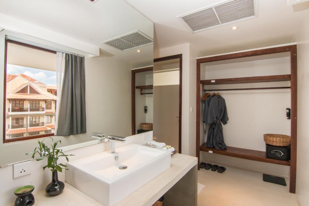 a bathroom with a white sink and a mirror at Apsara Residence Hotel in Siem Reap