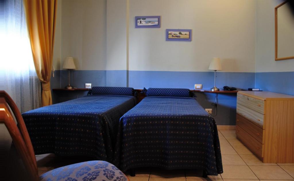 Postel nebo postele na pokoji v ubytování Hotel Morgana