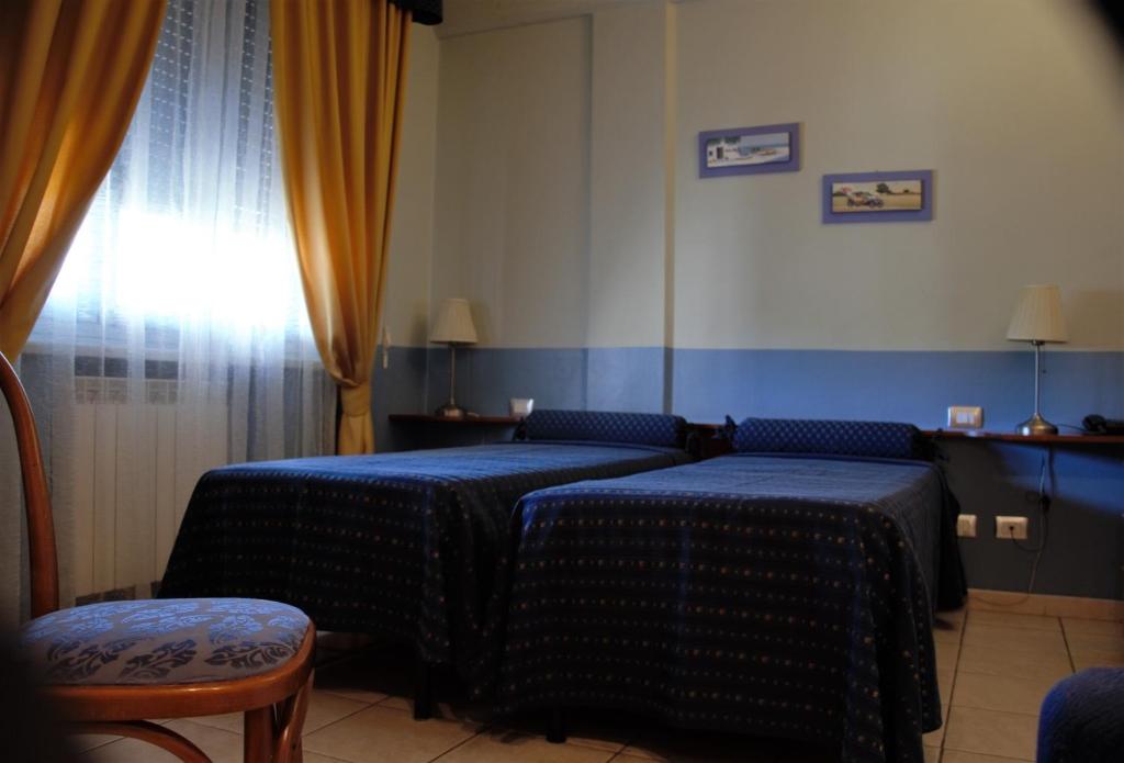 Postel nebo postele na pokoji v ubytování Hotel Morgana
