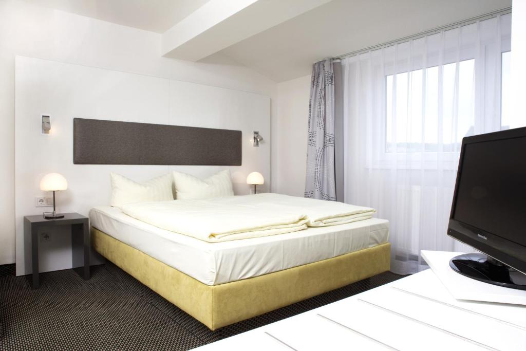 Postel nebo postele na pokoji v ubytování Rußmann Hotel & Living