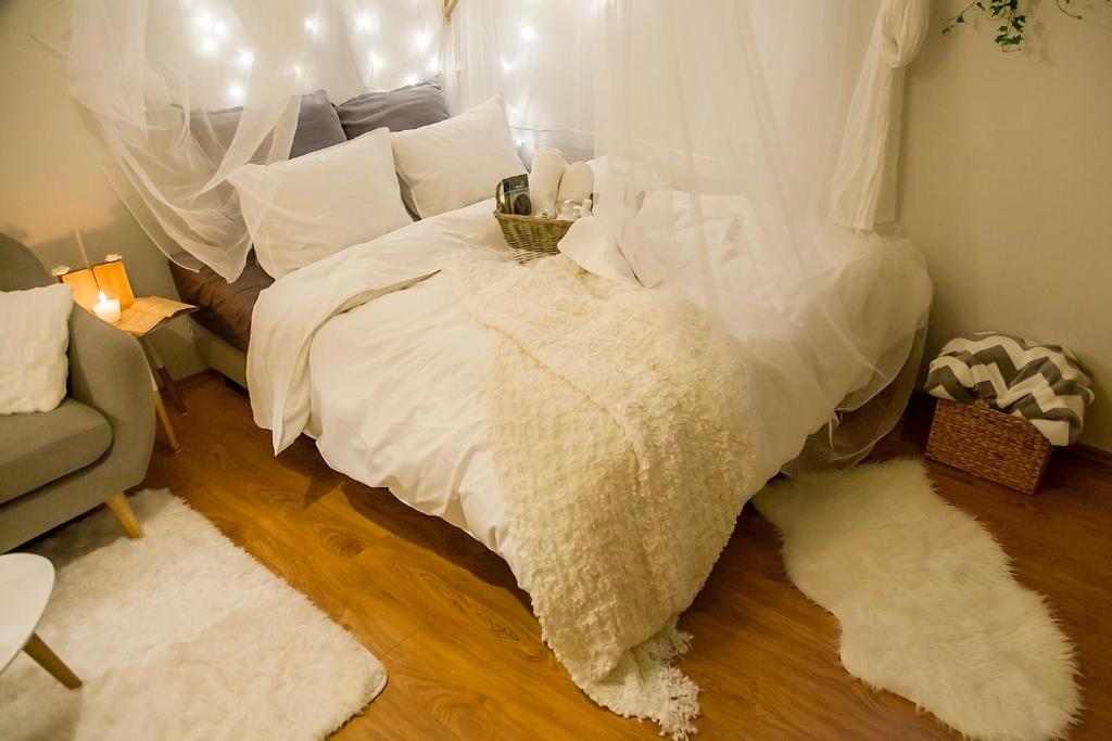 a bedroom with a bed with white sheets and pillows at The Nook Apartment in Zagreb