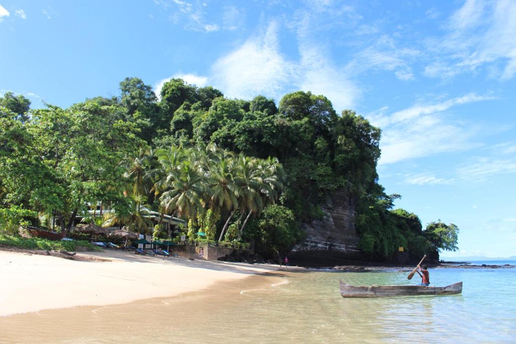 a man standing on a boat on the beach at Hotel Gerard et Francine in Ambatoloaka