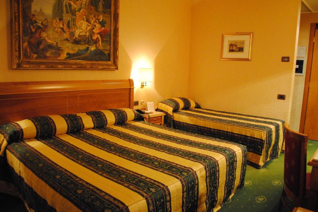 Postel nebo postele na pokoji v ubytování Colonna Hotel