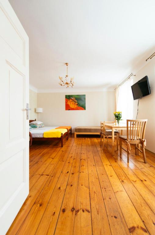 a room with a bed and a table and chairs at Medainie apartamenti in Liepāja