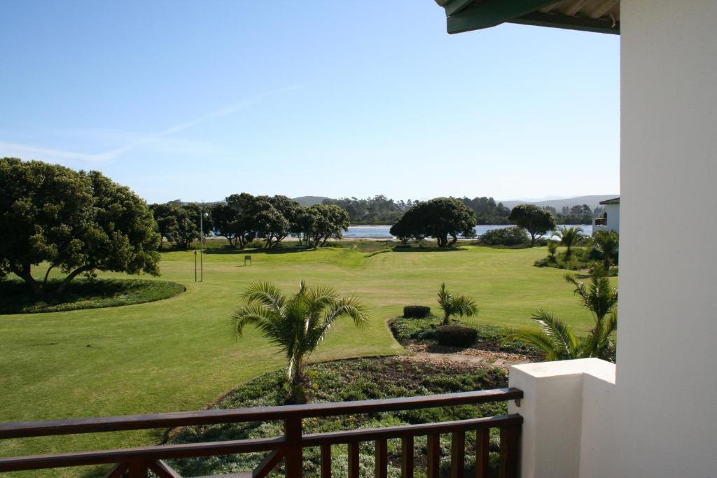 a view of the golf course from the balcony of a house at Keurbooms River Lodge 1115 in Plettenberg Bay