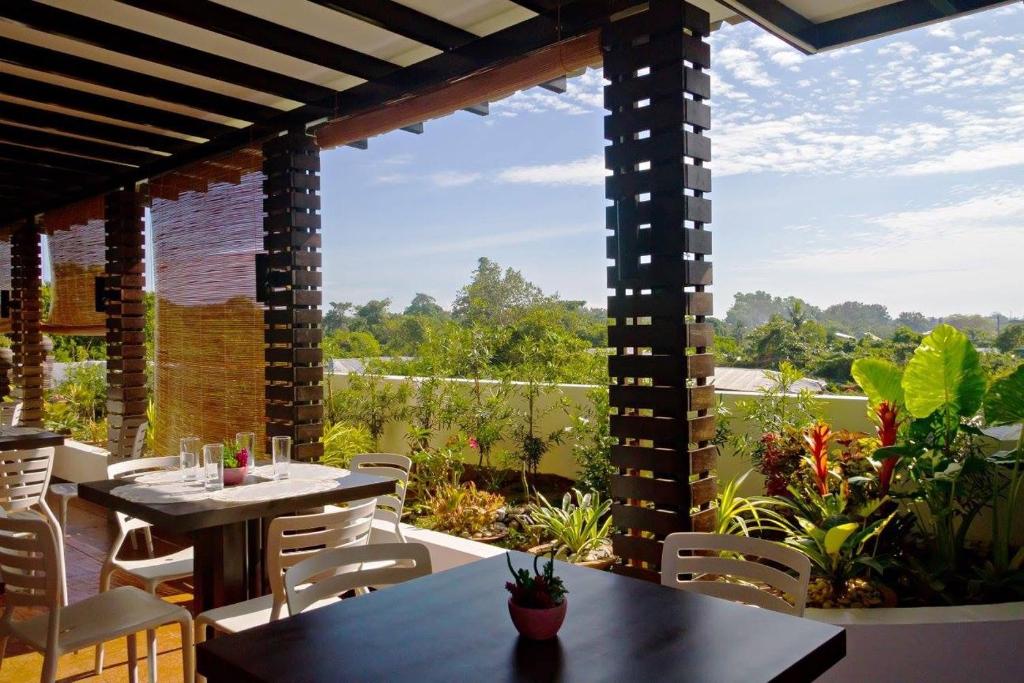 a patio with a table and chairs and a view at Globetrotter Inn - Palawan Inc. in Puerto Princesa City