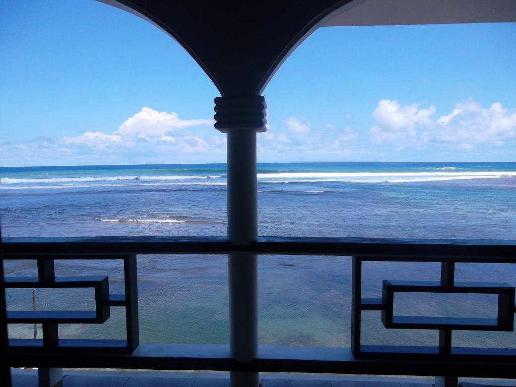 a view of the ocean from a window at Calibishie Sandbar in Calibishie