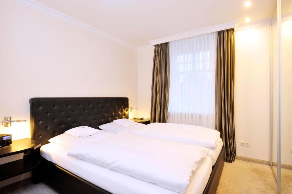 Postel nebo postele na pokoji v ubytování Hotel Strandhörn