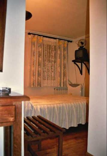 Postel nebo postele na pokoji v ubytování Hostal Las Coronas