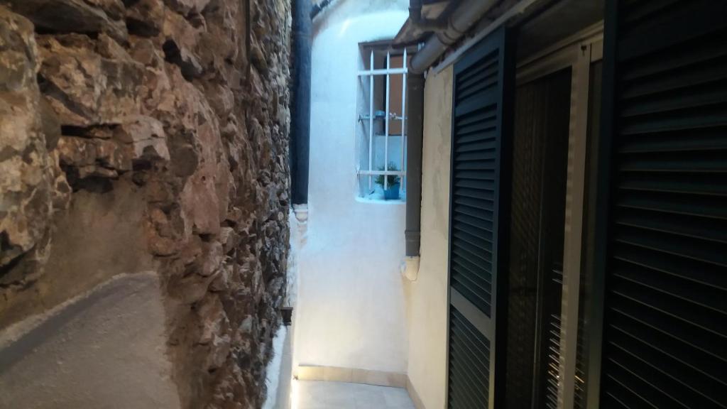 a door to a room with a window and a wall at Clara's House in Portofino