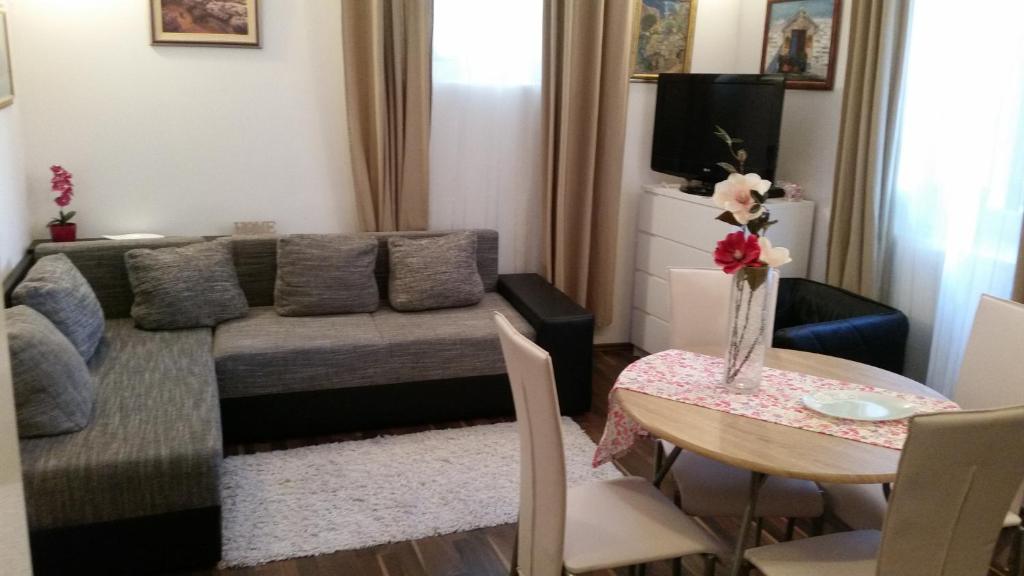 a living room with a couch and a table at Apartment Ines in Split