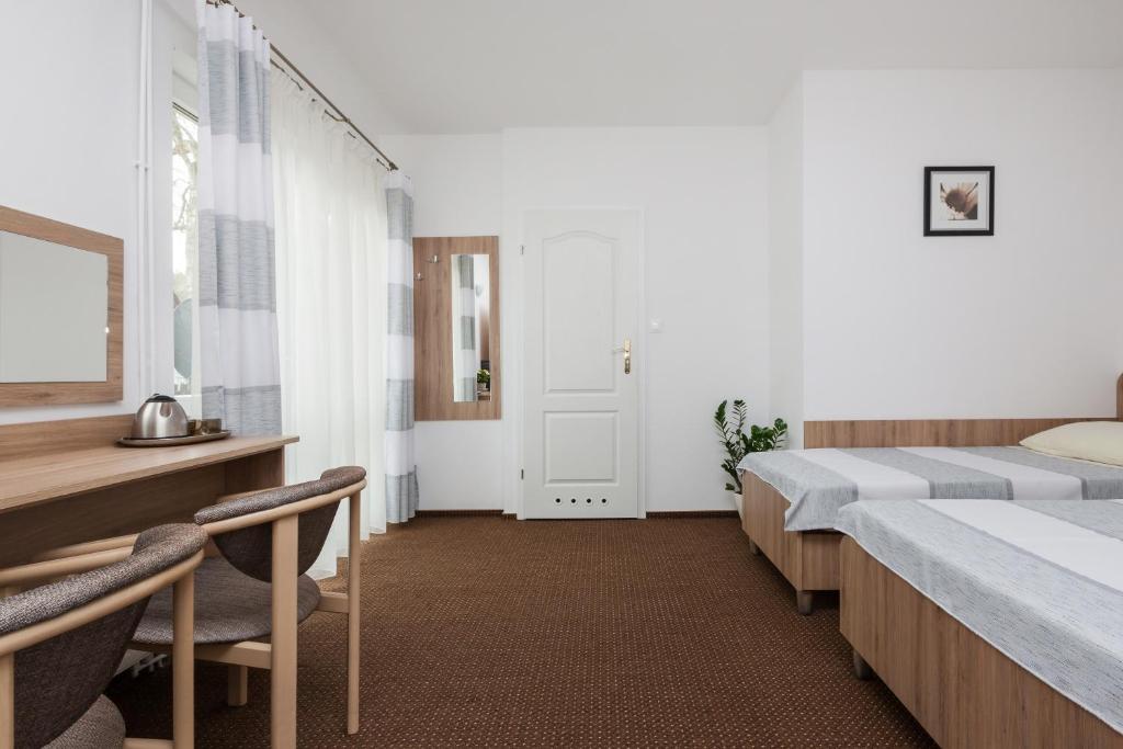 Postel nebo postele na pokoji v ubytování Dom Gościnny Oskar