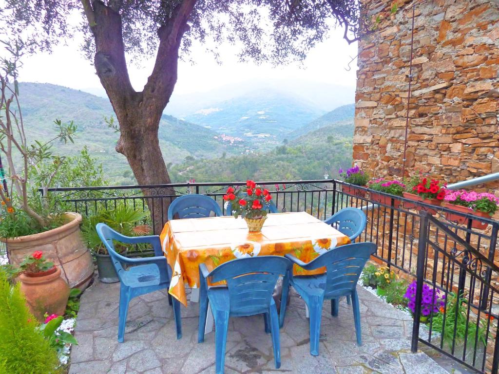 a table and chairs on a balcony with a view at Casa Mamma Rosetta in Civezza