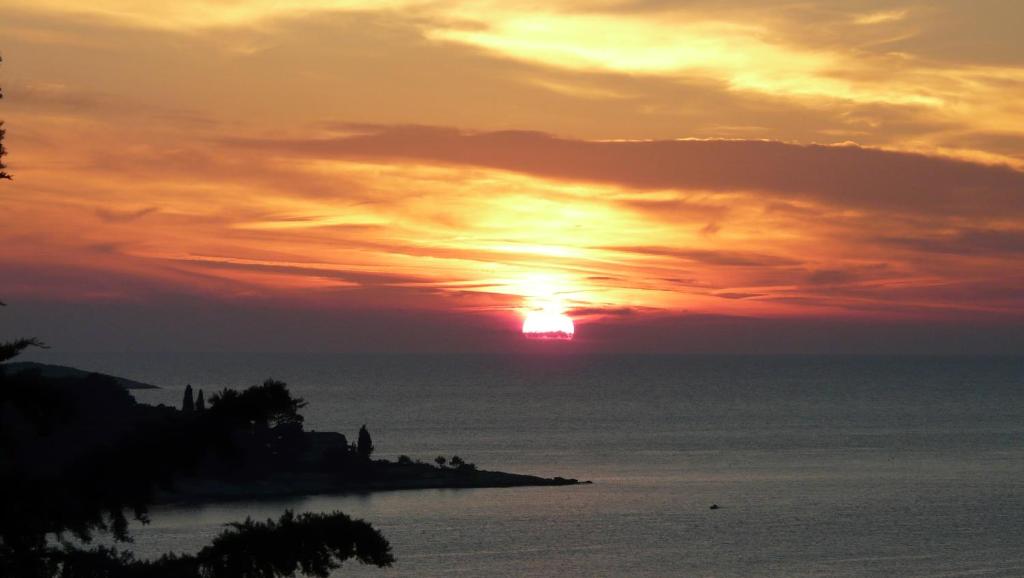a sunset over the ocean with the sun in the sky at Sea View Apartment in Cavtat