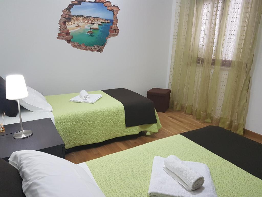 Postel nebo postele na pokoji v ubytování Villa Oliveira Apartments