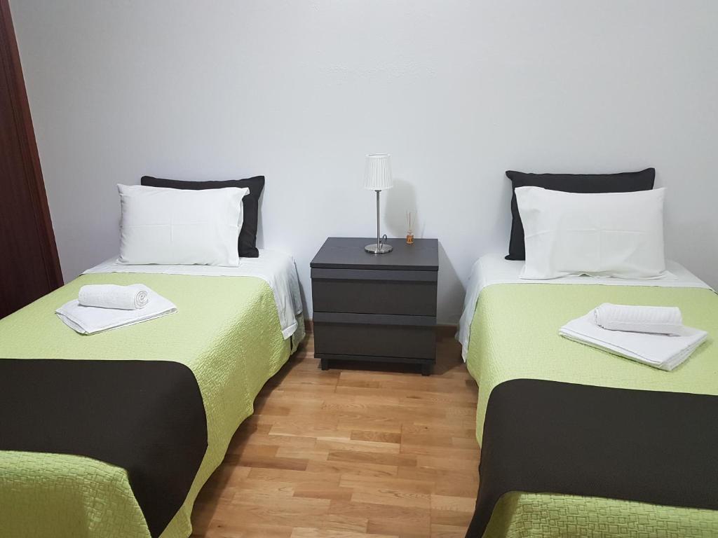 Postel nebo postele na pokoji v ubytování Villa Oliveira Apartments