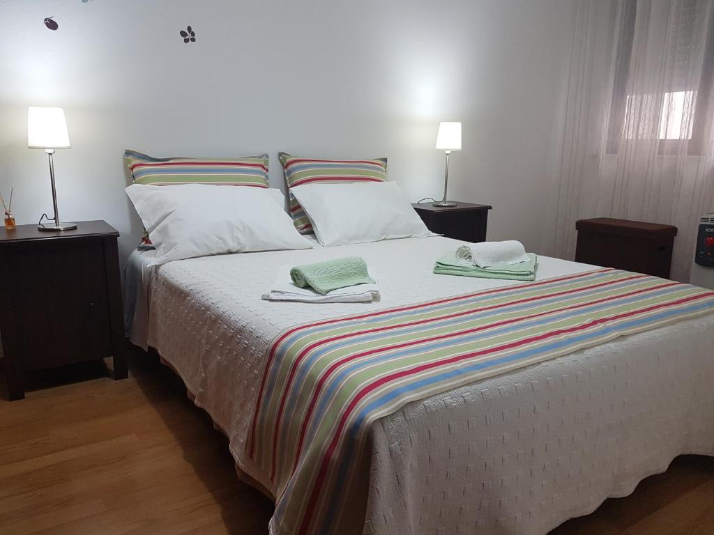 Postel nebo postele na pokoji v ubytování Villa Oliveira Apartments