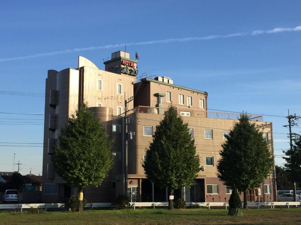 a building with a tower on top of it at Maebashi Business Hotel Luka in Maebashi