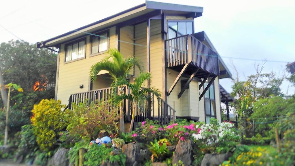 een geel huis met een balkon en een aantal bloemen bij Cottage Morino Paradiso in Onna