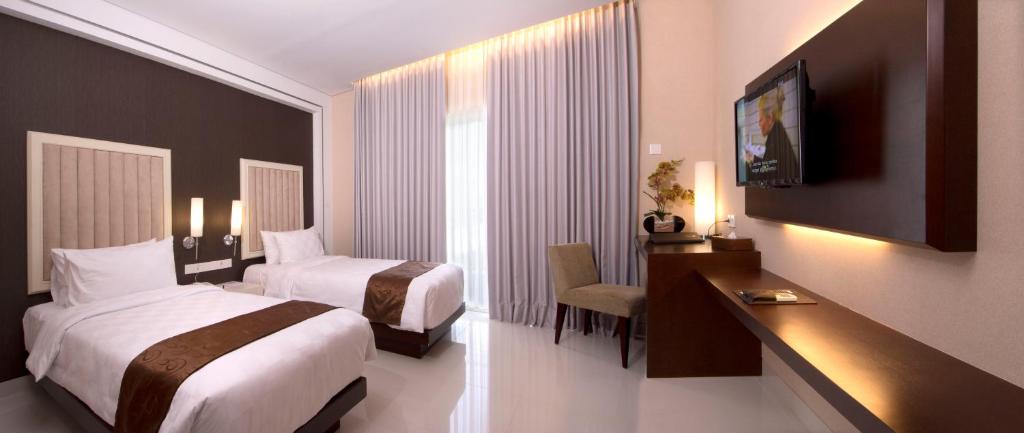 Tempat tidur dalam kamar di Gallery Prawirotaman Hotel