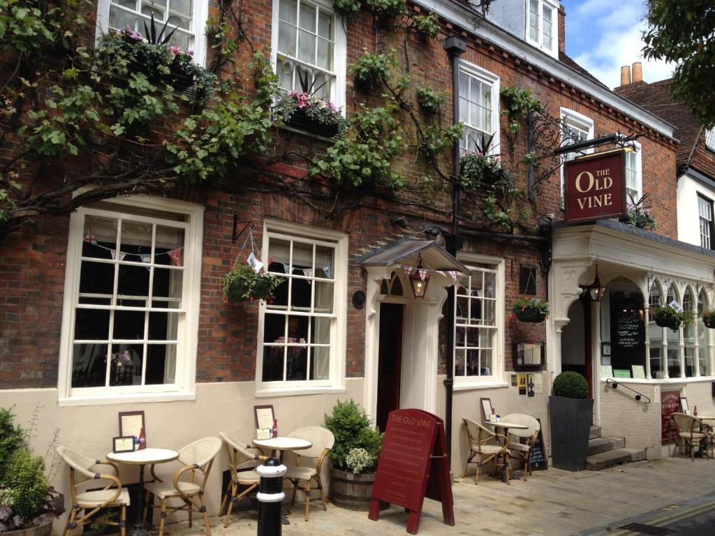 a restaurant with tables and chairs outside of a building at The Old Vine in Winchester