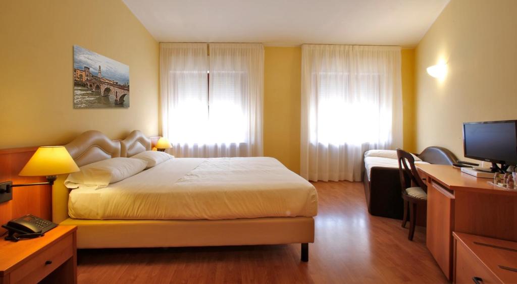 Postel nebo postele na pokoji v ubytování Veronello Resort