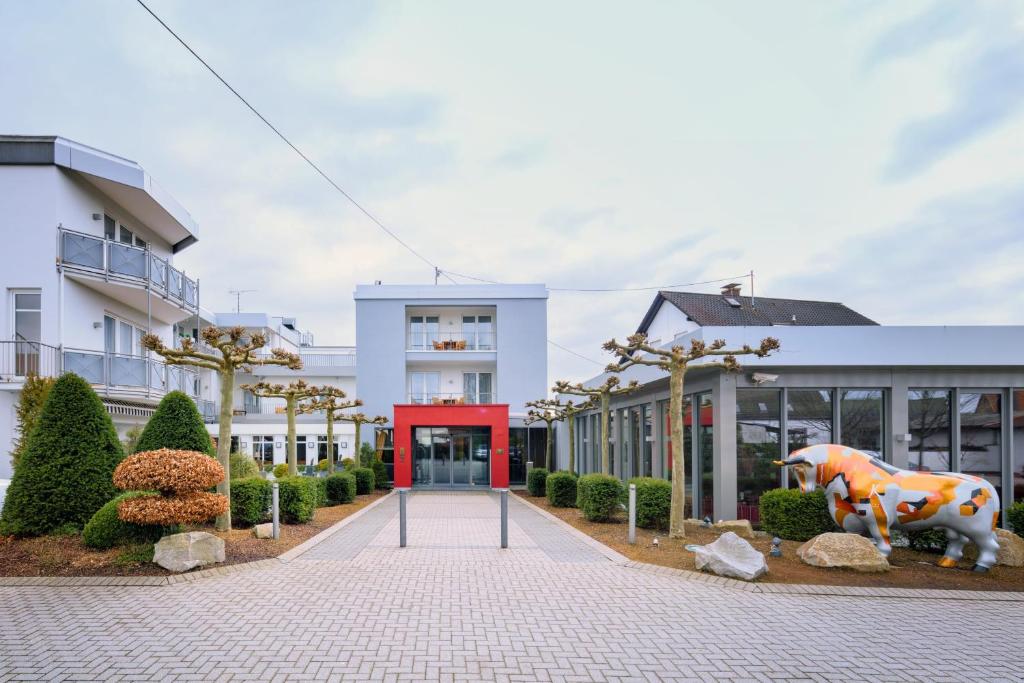 a building with a cow statue in front of it at Hotel-Restaurant Kunz in Pirmasens