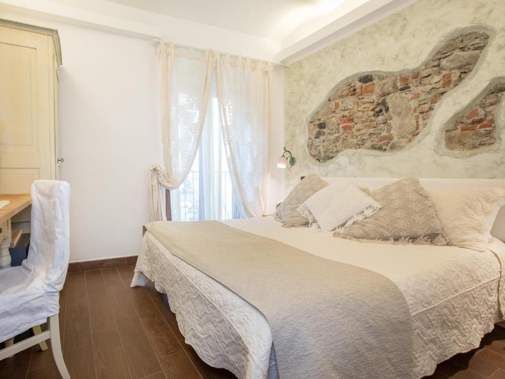 a bedroom with a bed and a large window at Hotel Marina in Monterosso al Mare