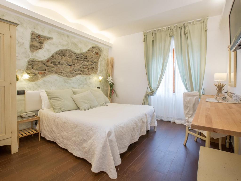 a bedroom with a large bed and a large window at Hotel Marina in Monterosso al Mare