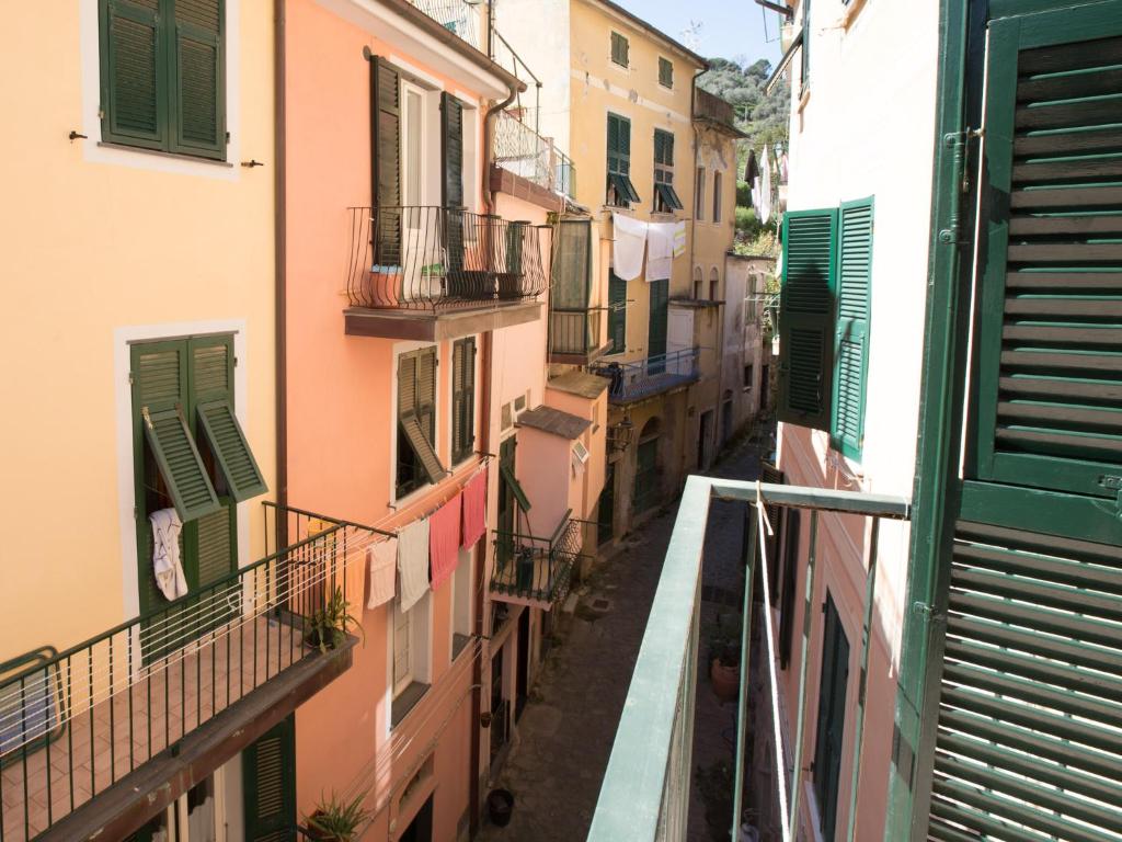 an alley with clothes hanging from the balconies of buildings at Hotel Marina in Monterosso al Mare