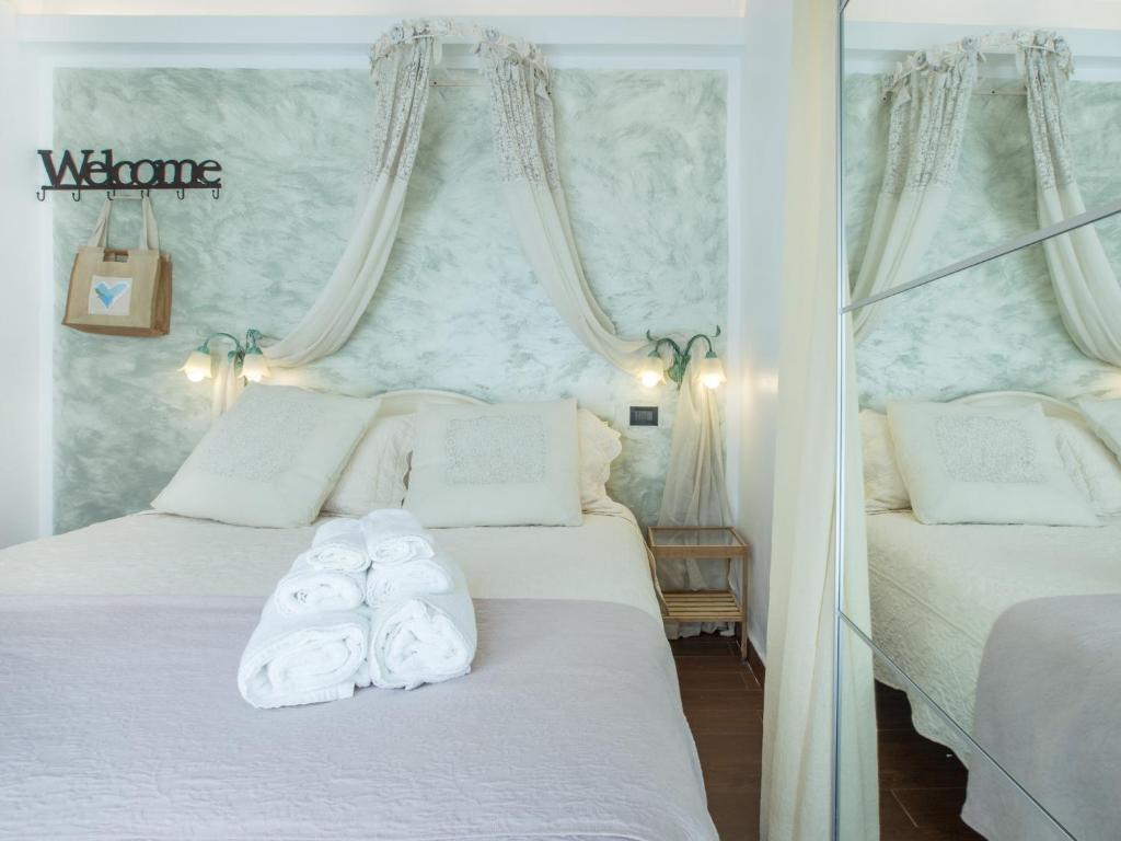 a bedroom with two beds with towels on them at Hotel Marina in Monterosso al Mare