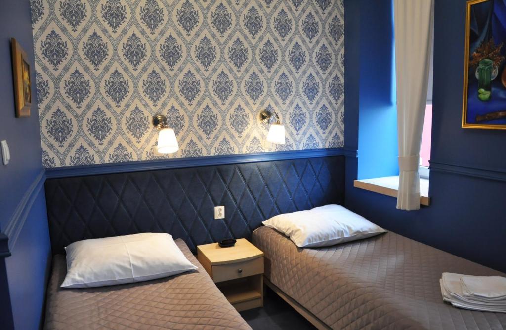 Łóżko lub łóżka w pokoju w obiekcie Willa Impresja Hotel i Restauracja