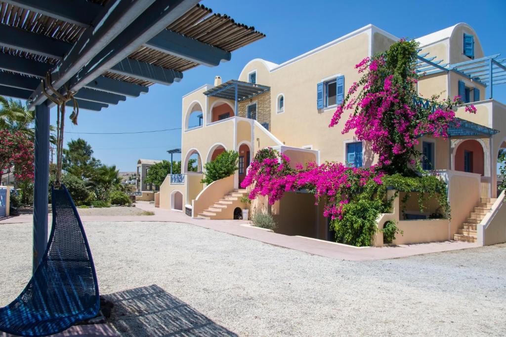 a house with flowers in front of it at Asterias Mini Coastal Apartments in Perivolos
