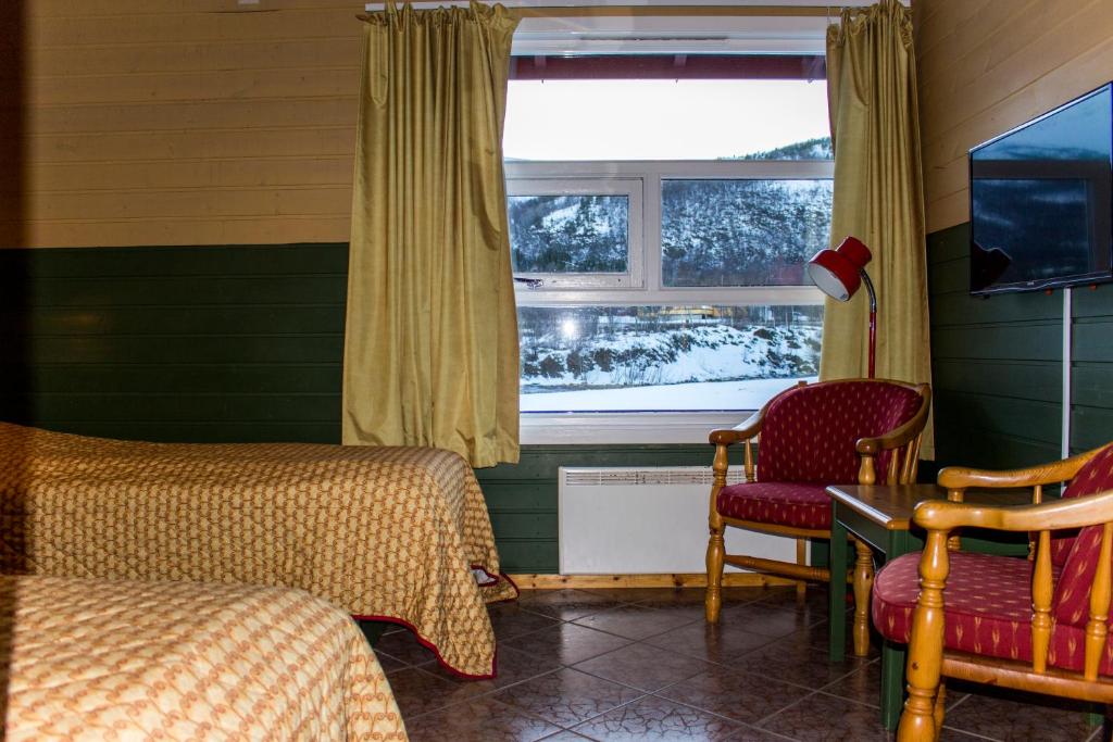 a room with two beds and a window at Tysfjord Hotel in Storjord I Tysfjord