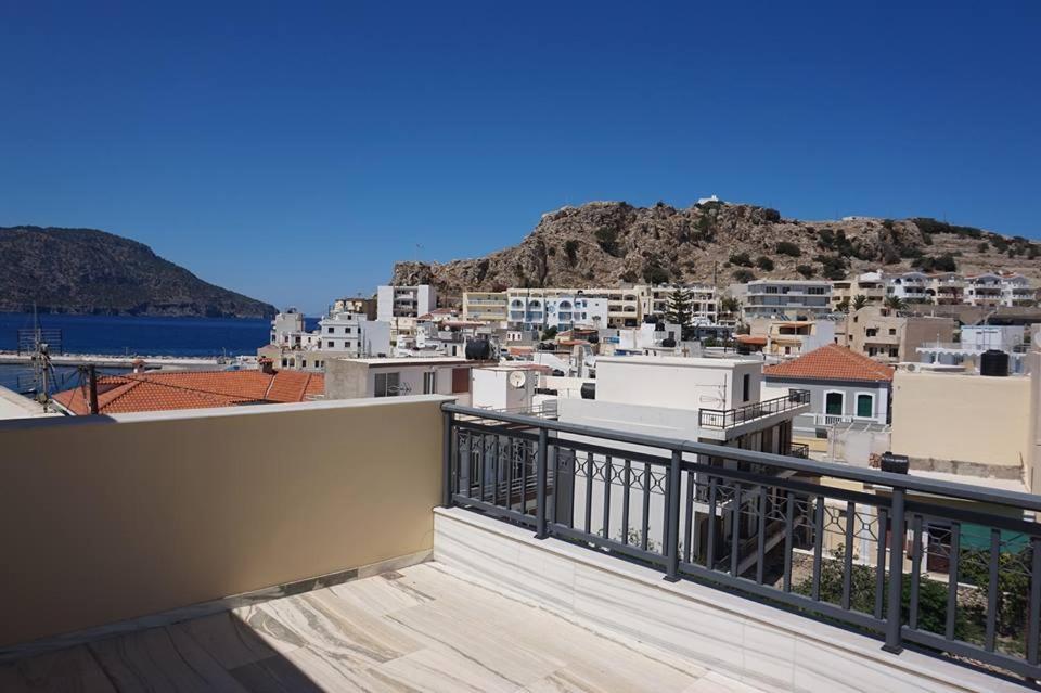 a balcony with a view of a city at Artemis House in Karpathos