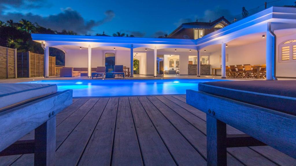 a luxury house with a swimming pool at night at Villa La Ressource in Le François